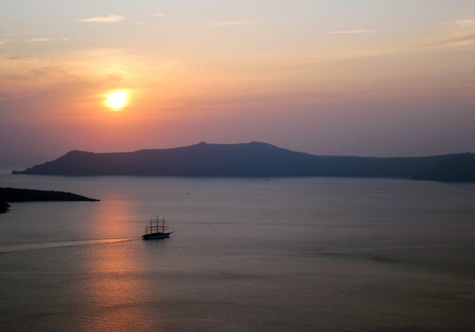 Ship Near Santorini Volcano at Sunset
